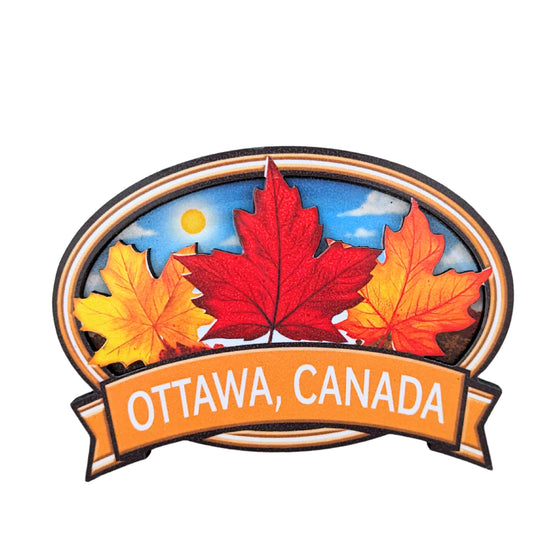 Orange bordered oval shaped wooden magnet. Vibrant Canadian fall maple leaves centered. The leaves embedded in the boarder. "Ottawa, Canada" in gold written underneath.