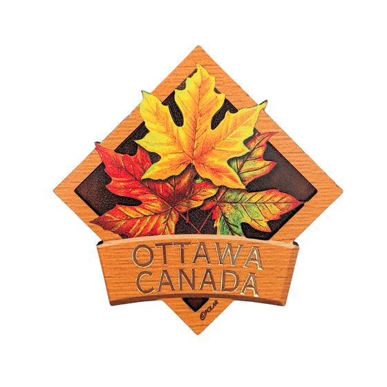 Orange bordered diamond shaped wooden magnet. Vibrant Canadian fall maple leaves centered. The leaves embedded in the boarder. "Ottawa, Canada" in gold written underneath.