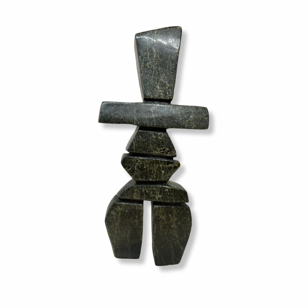 A tall, pear-shaped inukshuk carved from very dark green soapstone.