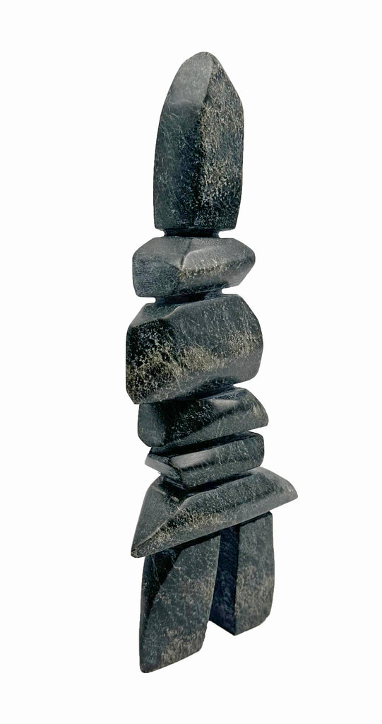 A tall, angular inukshuk made of tapering slabs stacked on top of each other.
