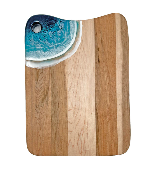 A medium serving board made out of maple wood. In the corner are blue acrylic ocean waves.