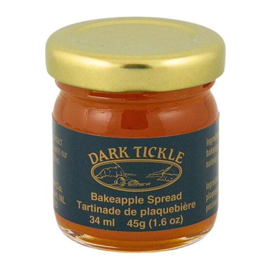 Small Glass Jar of Bakeapple Spread from Dark Tickle in Newfoundland. Jam is orange/ yellow in color and is sealed with a gold tin lid.