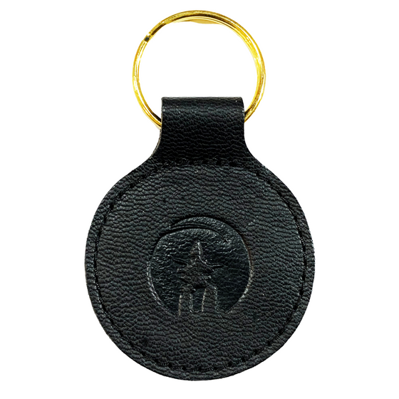 Black leather sealskin key ring with inukshuk embossing in the centre. 