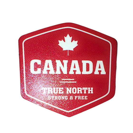 Wooden magnet with gloss finish. Red background with white print of a canadian maple leaf above "Canada True North  Strong and Free". 