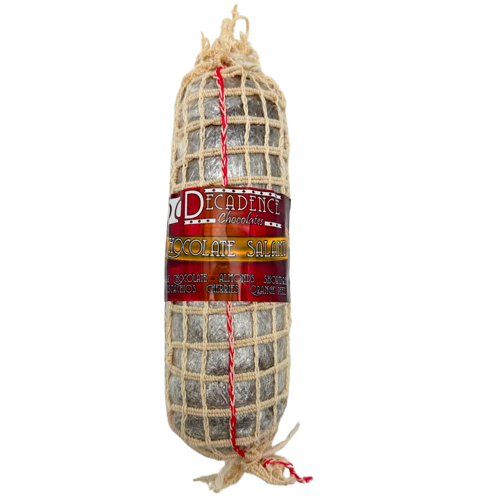 The dark chocolate cylinder of 'salami' is wrapped in a white net package, with a red and yellow label listing its ingredients.