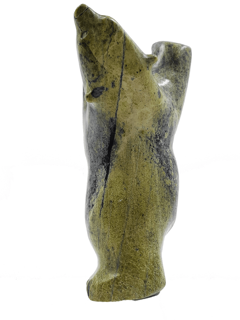 A dancing bear carved from brilliant green soapstone. The bear dances on one hind foot, with the other raised and its paws thrown up in front of it. The bear throws back its head in jubilation. This bear faces away.