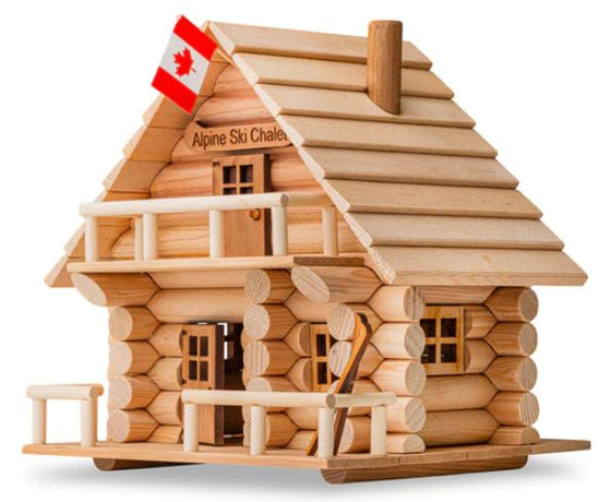 A two-tier ski lodge made of interlocking logs. An inviting porch fenced by rustic hewn logs fronts the first floor and matches the balcony on the second floor. A wooden pair of skis leans against the railing of the porch, beside an inviting window. A Canadian flag hangs from the front apex and the steep roof also features a chimney. A canoe-shaped sign reads "Alpine Ski Chalet."