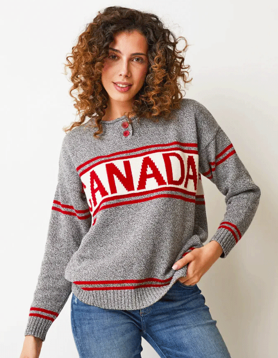 A salt-and-pepper grey sweater, with sets of two red strips around the cuffs and bottom, upper arms, and upper and lower chest. Canada is written in red on a white strip spanning across the chest. Two red buttons form the Henley neckline.