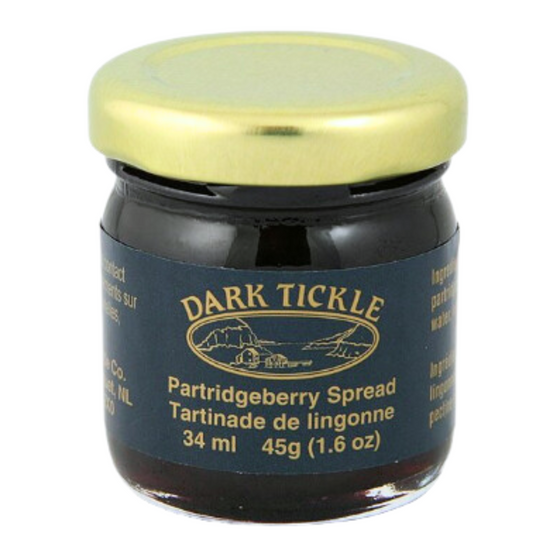 Small Glass Jar of Partridgeberry Spread from Dark Tickle in Newfoundland. Jam is dark purple in color and is sealed with a gold tin lid.