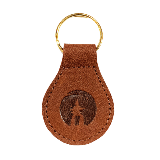 Brown leather sealskin key ring with inukshuk embossing in the centre. 