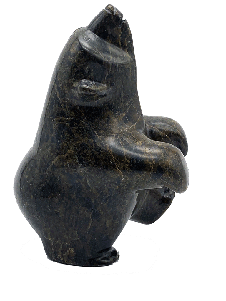 A dancing bear carved from greenish brown stone. This bear dances on one hind foot, with the other raised to one side and front paws raised. It throws its head back in jubilation. This bear faces right.