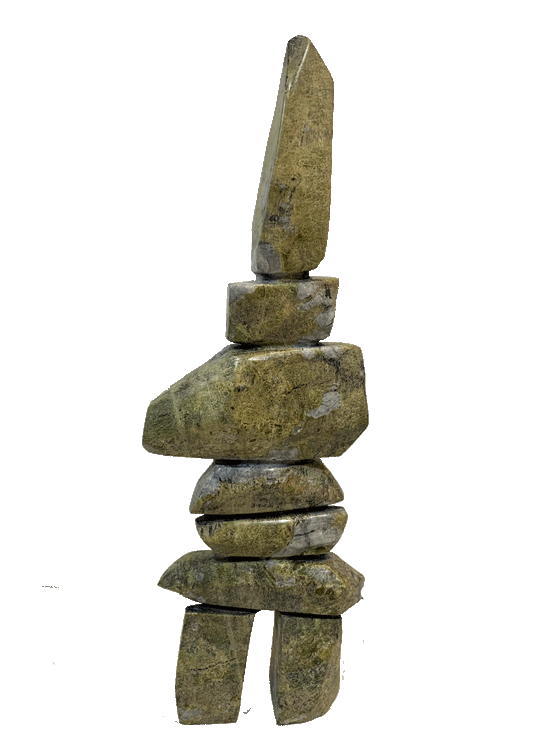 A tall inukshuk carved from greenish-brown stone.