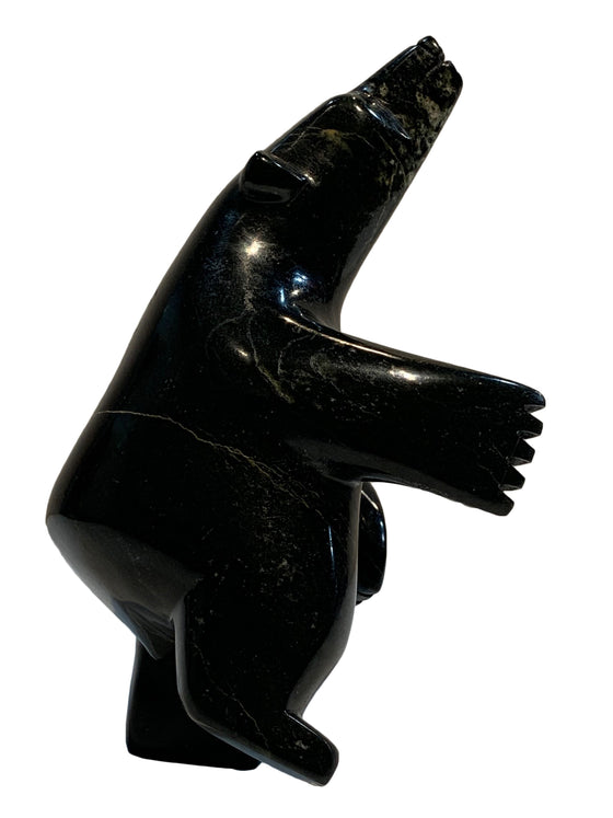 A dancing bear carved from jet black stone. This bear dances on one hind foot, with the other raised to one side and front paws raised. It throws its head back in jubilation. This bear faces right.