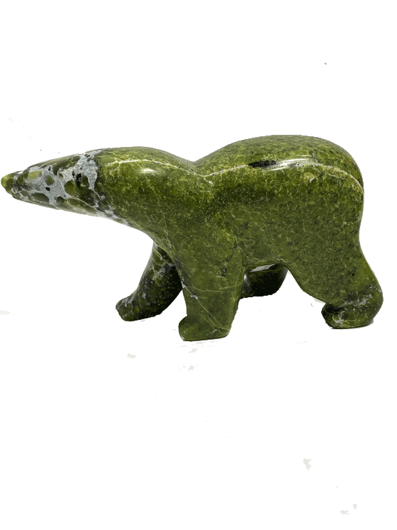 A long-necked bear carved from brilliant green soapstone walks on all fours. The head and forepaws are mottled with white, creating a beautiful contrast with the green. Its head is tilted to one side as though something has caught its attention. This bear faces left.
