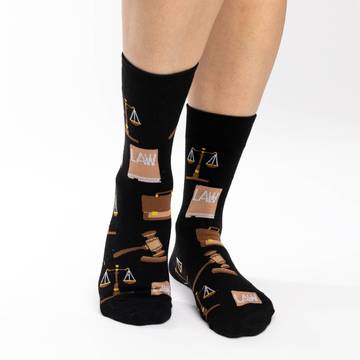 Get ready to serve up sweet justice wearing these black socks, adorned with courtroom icons such as the scales of justice, a briefcase, a law book and a gavel. 85% Cotton, 10% Polyester, 5% Spandex