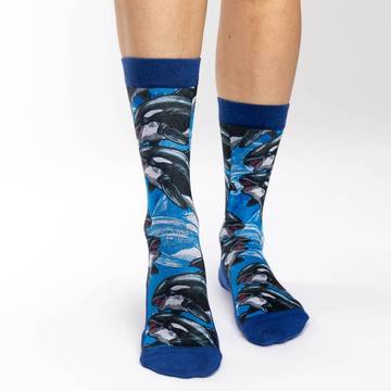 These active fit socks feature a print with several orca whales swimming around. These majestic sea creatures can now decorate your feet whether you're on or off the land. They are dark blue at the cuff and from the heel through the sole to the toe. 48% Polyester, 45% Cotton, 5% Elastic, 2% Spandex