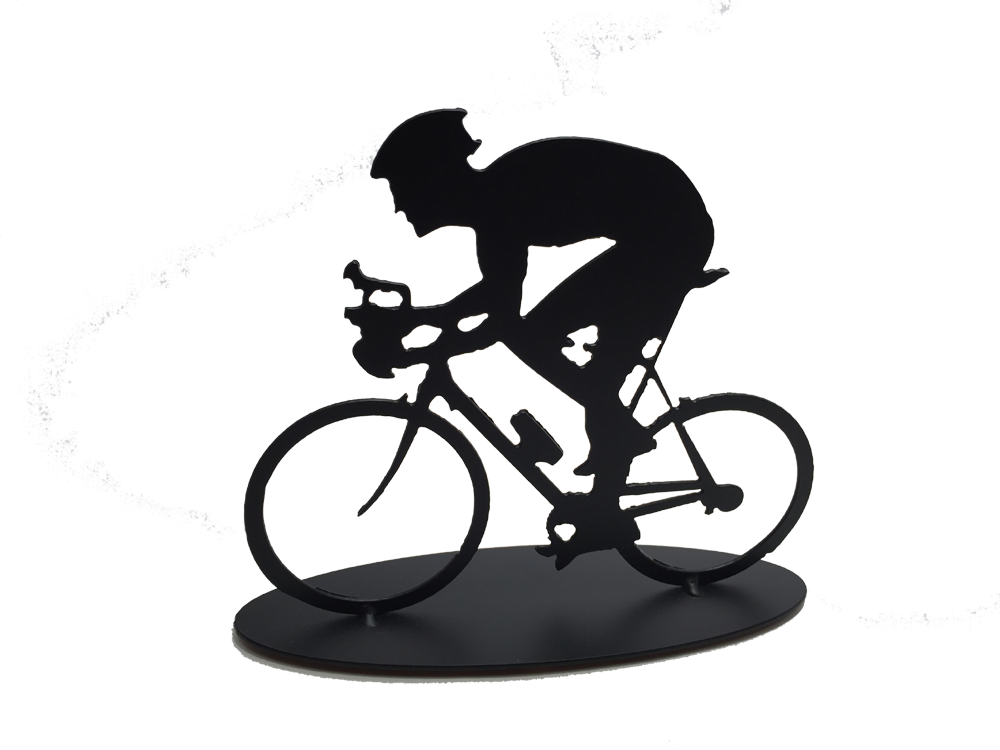 This metal sculpture shows the matte black silhouette a male cyclist hunched forward over their handle bars. He faces left and stares forward intently. The bike design is slightly simplified, and the wheels have no spokes. The piece stands on an oval base.