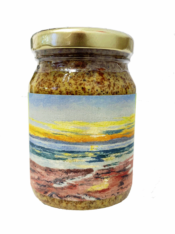 Clear jar with yellow grainy mustard inside. Label depicts PEI artist Ken Spearing's "The Sunset" - a blue, yellow and orange sunset sky with a blue ocean and pink rocks below.