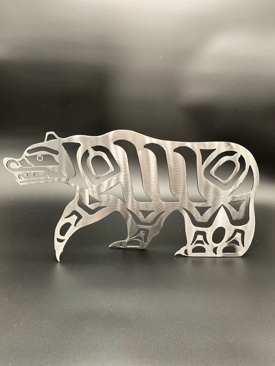 A Haida style walking bear made from brushed steel. The strong lines of the design imply a powerful creature.