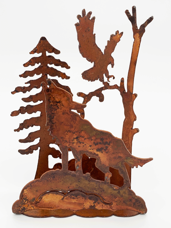 A 3-dimensional tableau of a howling wolf, soaring eagle, and bleak pines, cut from warm, weathered steel. The unique dappling of the oxidized steel makes each piece one-of-a-kind.