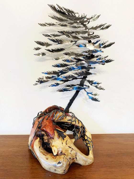 Steel windswept pine tree fitted onto a piece of Canadian polished wood. 