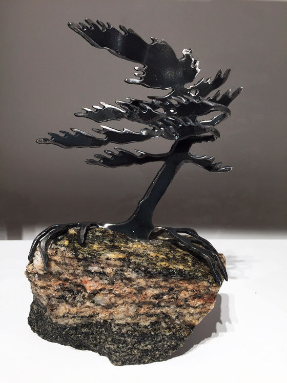 Steel windswept pine tree fitted onto a piece Canadian stone. 