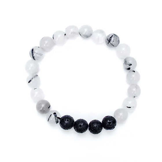 Our Canadian made aromatherapy "Balance" bracelet  is made with 8mm Tourmalinated quartz and lava beads, which is a clear quartz with accents of black tourmaline and is known for its grounding abilities, enhancing feelings of calm, stillness and protection
