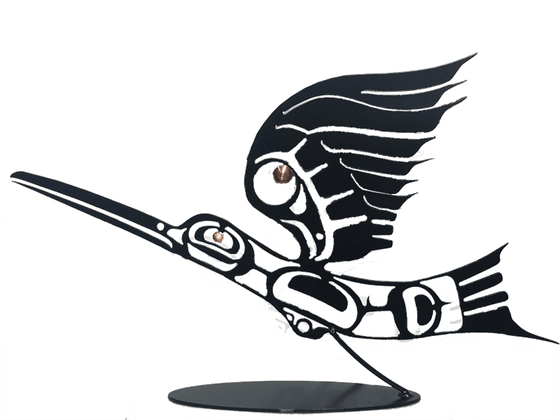 This metal sculpture shows the matte black silhouette of a hummingbird drawn in Coastal Salish style. The hummingbird is midflight, with its back arched slight downward and it wing stretched high above its head. Its long beak is two thirds the length of its body. A small copper disk marks the eye of the bird, and a slightly larger disk provides detail to the wing. A small angled rod connects the base of the bird to its oval base.