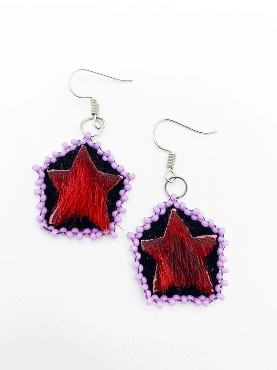 red seal skin, star shaped drop earrings with pink beads around the border.