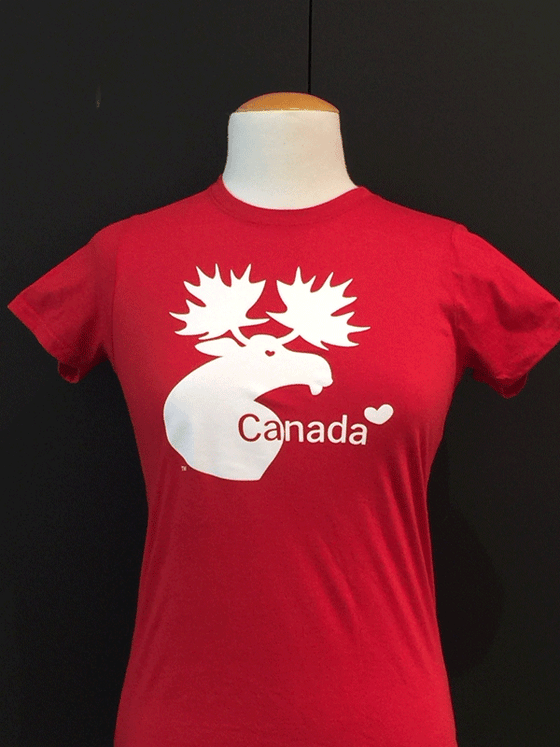 A red shirt. In the middle is the Made in Canada Gifts logo in white, as well as text that says "Canada" with a little heart beside it.