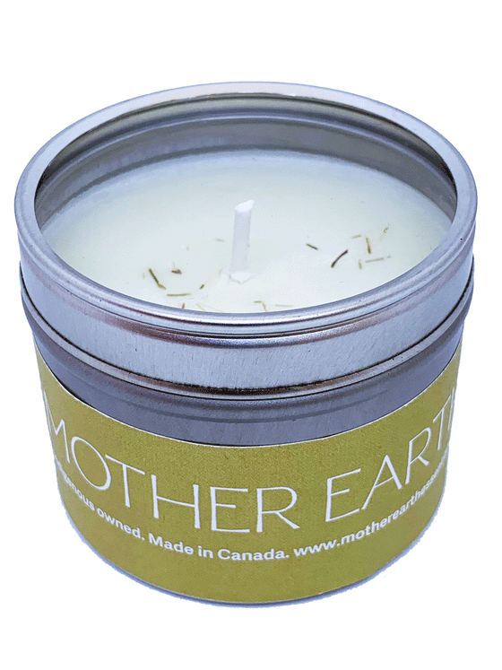 small circular tin candle. The Lid is transparent. The candle is wrapped in a green label that says Mother Earth on It.