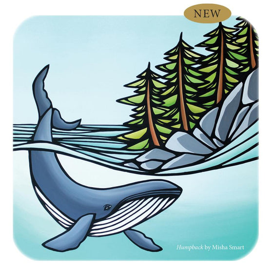 A square tin box with Misha Smart's artwork titled Humpback on the lid. A humpback whale is depicted in blue water with its tail sticking out, next to a rocky shore with several green trees.