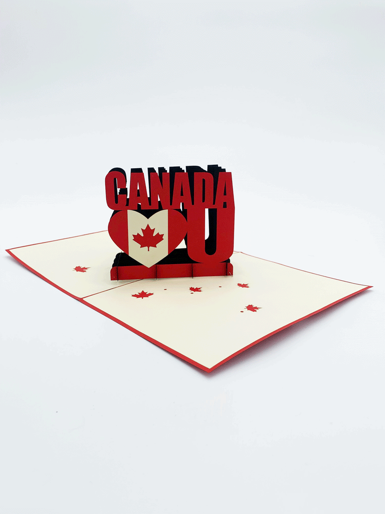 Inside of card. 3-D words that say "Canada heart U". The heart is a heart shape with the Canadian flag in the shape of the heart. Maple leaves are scattered flat on the page. 