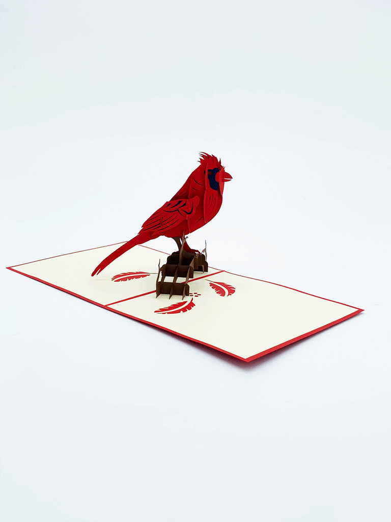 Inside of card. 3-D red cardinal that is standing on a branch. Flat on the page there are red feathers.