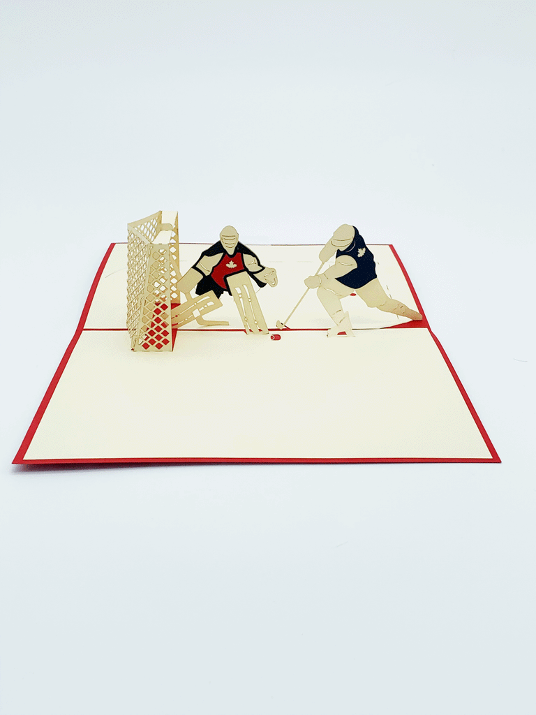 Inside of card. 3-D hockey players, one wearing a red jersey and the other wearing a blue jersey. The net is also 3-D. The red jersey player is protecting the net while the blue player is taking a shot on the net. 