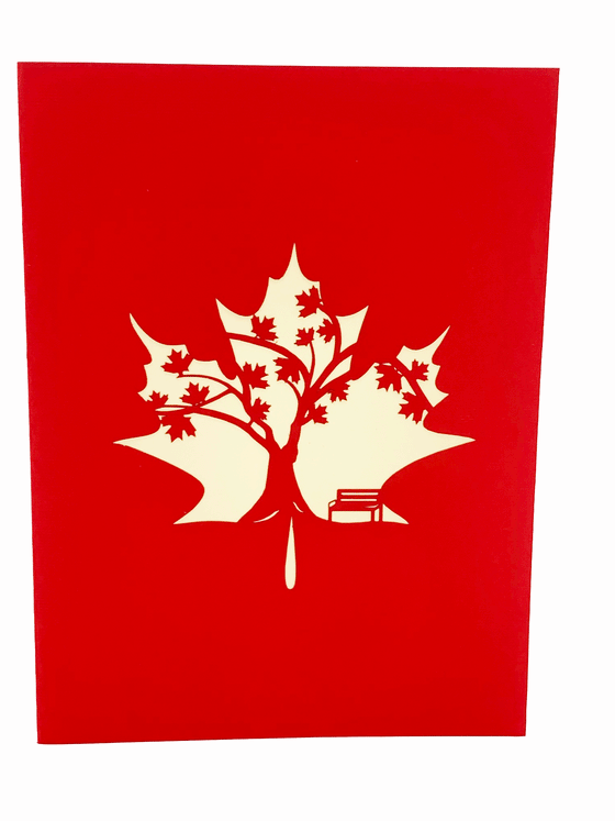 An intricately made maple tree 3D pop-up art card with a 3D bench besides the tree