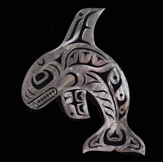 A Haida whale arches as though in breach this this brushed steel sculpture. Strong lines and detail give the piece a sense of power and movement.