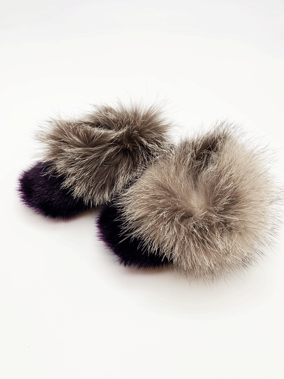 Sealskin slippers. The fur around the foot is a dark purple colour, and the top of the slippers have a light grey fluffy fur.
