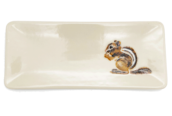 A handpressed shallow rectangular plate made of white clay. To one side, a chipmunk is handpainted using a combination of traditional brush and sgraffito.