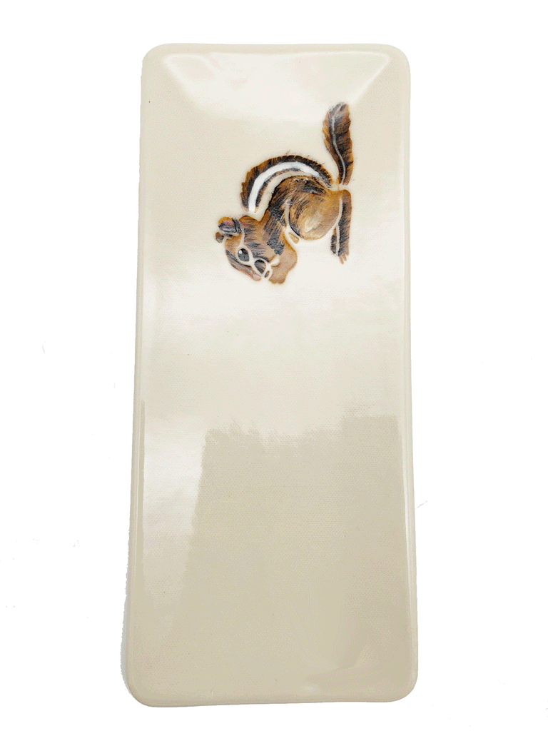 A handpressed shallow rectangular plate made of white clay. To one side, a chipmunk is handpainted using a combination of traditional brush and sgraffito.