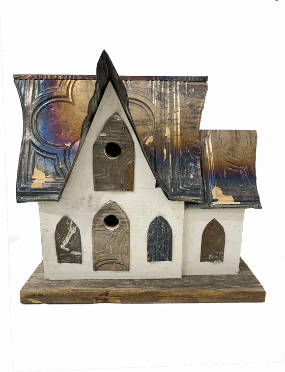 Beautiful handcrafted wooden bird house with a steel roof and vibrantly painted walls. The metal roof has multi-coloured hue creating a unique home for birds.