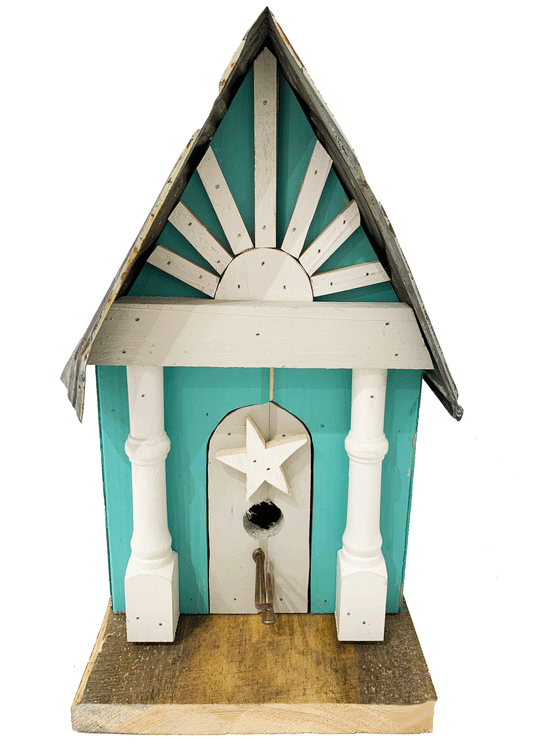 Beautiful handcrafted wooden bird house with a steel roof and vibrantly painted walls. A door way has a hand carved star hanging above the opening. 