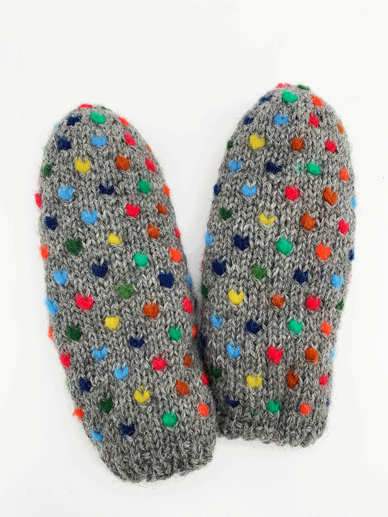 A grey pair of knit mittens with small colourful hearts. Colours consist of red, blue, yellow, orange, dark blue, green, and light blue.
