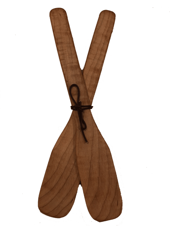 Two paddle-shaped wooden serving spoons crossed in the center and tied with leather cord. The wood's natural colour and grain give each paddle a unique appeal.