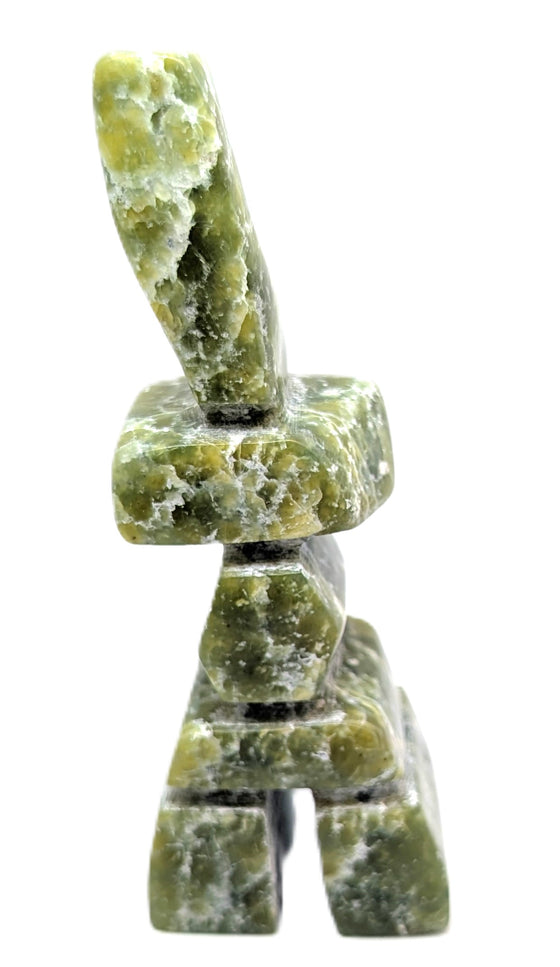 A green and white marbled inukshuk soapstone carving.