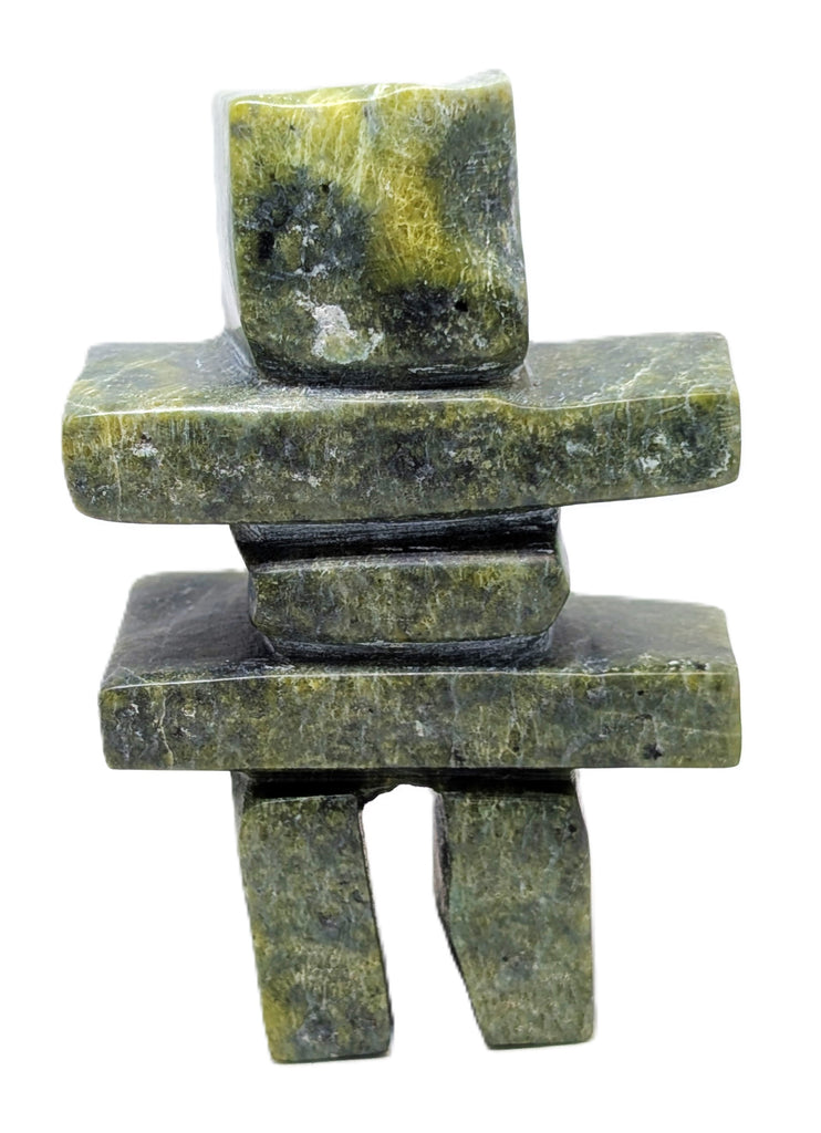 A green and black inukshuk soapstone carving.