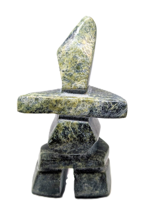 A green and black marbled inukshuk soapstone carving.