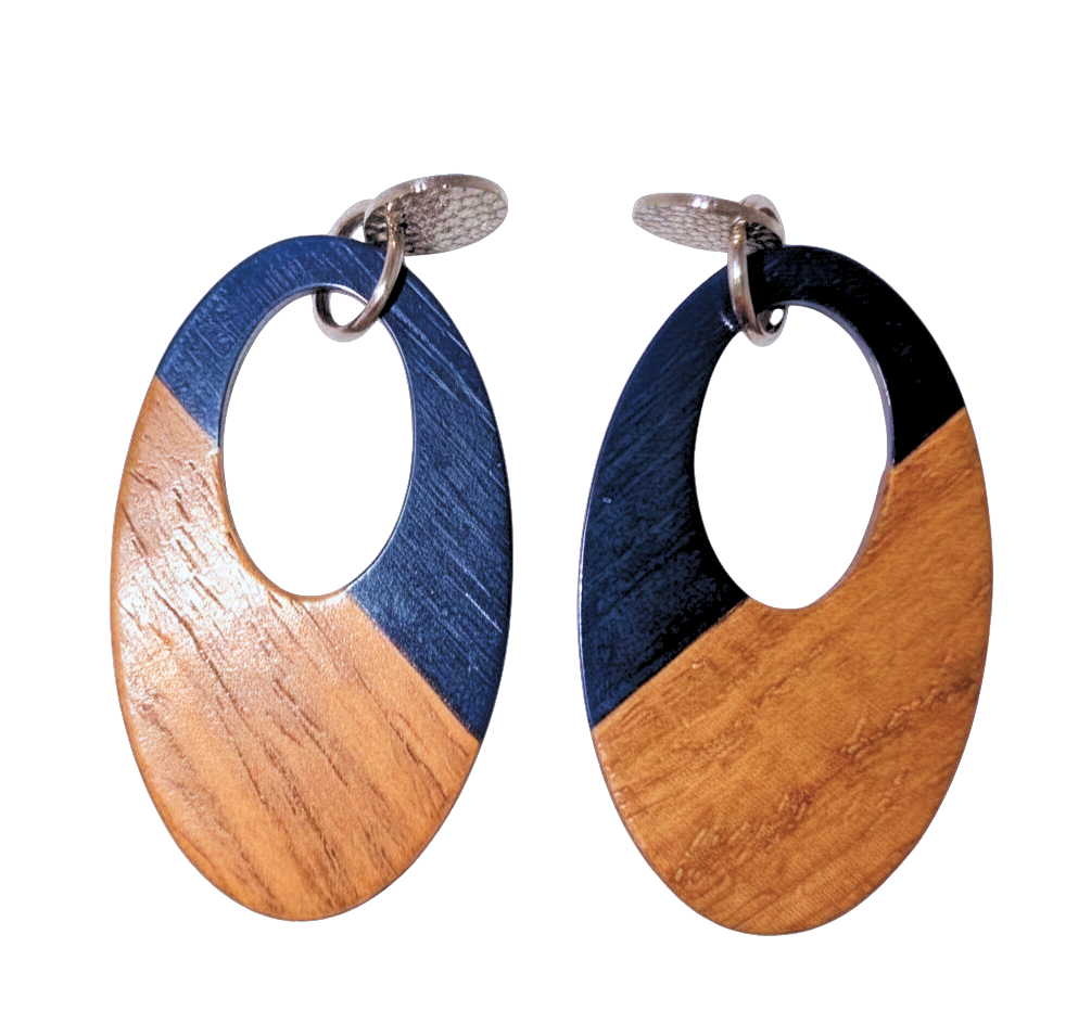 A pair of oval stud drop earrings with a cutout in the middle. The top half is blue and the bottom is walnut wood. Hardware is silver.