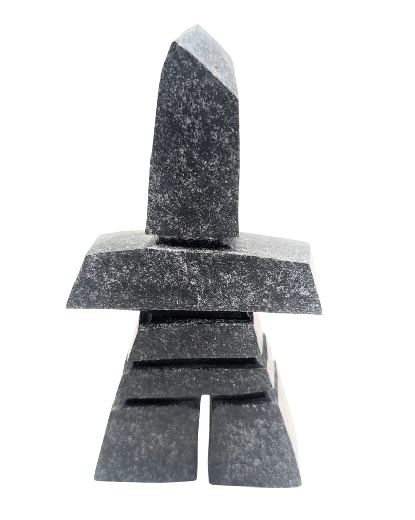 A grey marbled inukshuk soapstone sculpture.