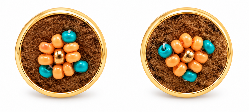 A pair of gold post earrings with round brown moose hide facepalm charms featuring blue and orange beaded flower details, shown on a white background.